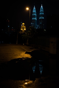 The spectacular Petronas Towers seen here from one of the side streets after a rain.