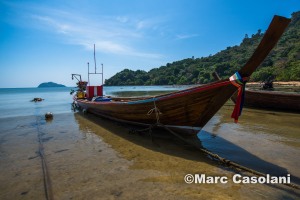 One of the many long tail fishing boats at low tide.