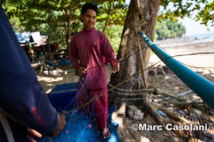 The tiring job of having to go through whole fishing nets and make sure they are free of crabs and holes. 